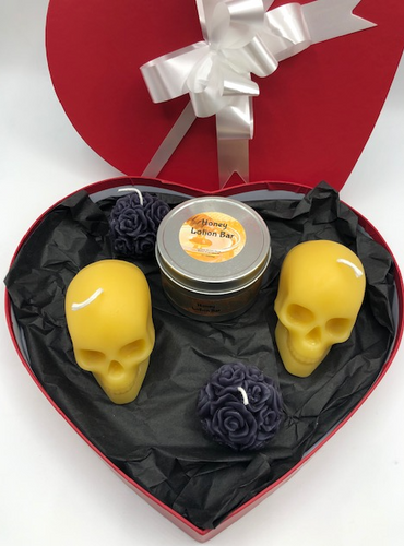 Skulls and Roses Valentines Day Gift Set in a heart shaped box.  Set includes 2 votive sized beeswax skull candles, 2 dark colored beeswax rose ball candles and 1 Honey Lotion Bar.  Perfect for that Goth or Skull Lover in your life.