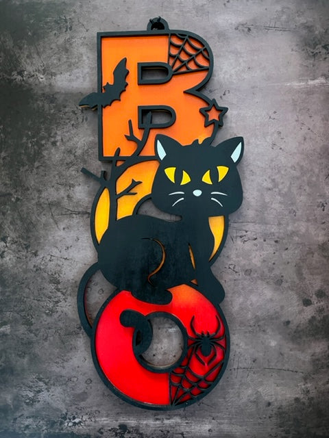 Light up your Halloween decor with this incredible Cat Boo sign.  The perfect addition to your spooky Halloween decor! This adorable black cat design is sure to charm your guest and add a playful touch to your home.  Featuring a whimsical black cat with bats and spider webs, this decorative piece sits atop the word 