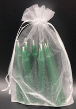 Load image into Gallery viewer, Set of 12 Chime Beeswax Candles.  These are the perfect candle to bring attention and intention to the moment.  Packaged in bags of 12.  Kept out of drafts and away from fans, these mini tapers will burn virtually dripless for roughly two hours.  Perfect for meditation, prayer candles, ritual candles or alter candles.  Available in Natural (gold) beeswax, cream, purple, pink, red, blue, green, orange, brown or black.  Shown in green in a pretty organza bag.
