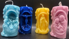 Load image into Gallery viewer, These beautifully detailed Religious Candles depict four different bible scenes - Jesus on the cross, the Virgin Mary, the Holy Family &amp; the Nativity manger scene.  Bring the spirit of Christ into your home with these gorgeous beeswax candles.  They make fantastic gifts, are great for Christmas decor, housewarming gifts, holiday centerpieces and alters.  Available in purple, blue or natural yellow beeswax.  **** Please note desired color when ordering.
