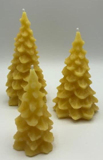 Christmas tree shaped beeswax candles available in three sizes. All natural. Handmade in the USA.