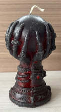 Load image into Gallery viewer, Our Witch Holding a Crystal Ball Beeswax Candle is an enchanting addition to any witchy, gothic or Halloween decor!  The intricate detailing around the base of the candle features decorative skulls.  The witch hand is adorned with bracelets, rings &amp; long, sharp fingernails adding to the eerie vibe of this incredible beeswax candle.  
