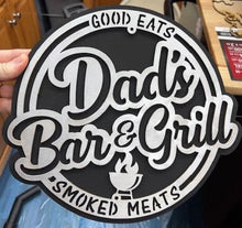 Load image into Gallery viewer, Surprise Dad this year with this Dad&#39;s Bar &amp; Grill, Good Eats, Smoked Meats sign to help him show off his barbeque skills.  Hand made, laser cut design.   Approx. size 12&quot; round
