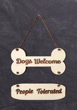 Load image into Gallery viewer, Welcome our furry friends into your home &amp; add a bit of humor to your entryway with this Dogs Welcome, People Tolerated sign.  Perfect for any dog lover!  Also makes a wonderful birthday or holiday gift.    Approx. Size 12&quot; wide x 24&quot; long
