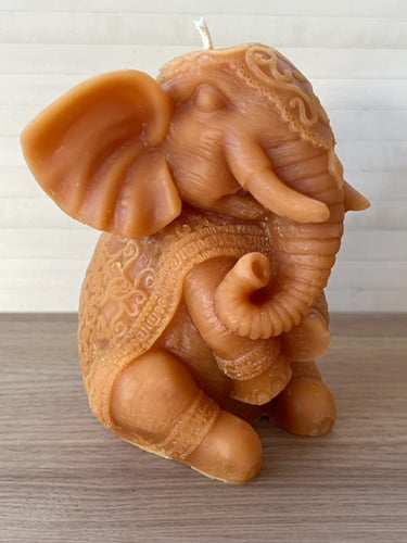 Gorgeous ﻿Elephant / Ganesh Beeswax Candle ﻿is adorned in a decorative blanket & headpiece.  Elephants are symbolized as removers of obstacles and a provider of fortune and good luck.