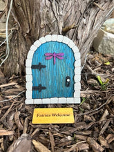 Load image into Gallery viewer, Welcome magic into your life with these whimsical fairy doors!  The doors shimmer, have a Fairies Welcome door mat &amp; have a dragonfly door hanger on them.  Perfect for fairy gardens or to add a bit of whimsey to any room.  
