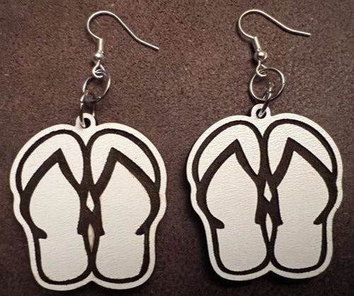 Our adorable Flip Flop Dangle Earrings - the perfect accessory for anyone who loves summer and wants to add a touch of sunshine to their outfit!  These earrings feature a cute flip flop designs with intricate details and that will make you feel like you're walking down a sandy beach. The dangle style of these earrings allows for movement and adds an extra element of fun to your look.