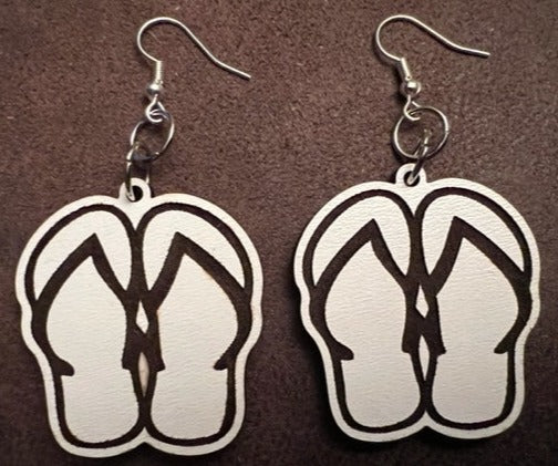 Our adorable Flip Flop Dangle Earrings - the perfect accessory for anyone who loves summer and wants to add a touch of sunshine to their outfit!  These earrings feature a cute flip flop designs with intricate details and that will make you feel like you're walking down a sandy beach. The dangle style of these earrings allows for movement and adds an extra element of fun to your look.