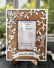 Load image into Gallery viewer, This Hummingbird Photo Frame is the perfect way to display your cherished memories with loved ones. This unique and personalized photo frame can be customized with up to 20 names in the hearts hung around the frame and custom wording in the banner across the bottom, making it a special and meaningful addition to any home decor. Available for a 4&quot; x 6&quot; or a 5&quot; x 7&quot; photo.
