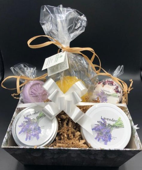 Lavender themed gift basket all ready to deliver to your loved ones. Basket includes a body butter, a lotion bar, a bath bomb, an all natural beeswax candle (unscented) & a soap bar. An additional body butter or bath product can be substituted for the candle. Handmade in the USA.