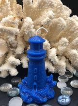 Load image into Gallery viewer, This Lighthouse beeswax candle takes you back to the sea &amp; promises to bring images of the seashore to your dreams.  Perfect for nautical or coastal themed decor or as a gift to the beach lover in your life.  Allow this stunning candle to envelop your room in a warm glow with a sweet honey aroma.  Shown in blue.  Also available in natural yellow beeswax.  
