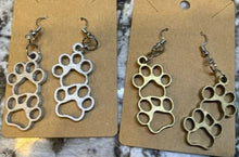 Load image into Gallery viewer, Add a bit of pet love flare to any outfit with these Paw Print Dangle Earrings!  The perfect  gift for your dog or cat loving friends.
