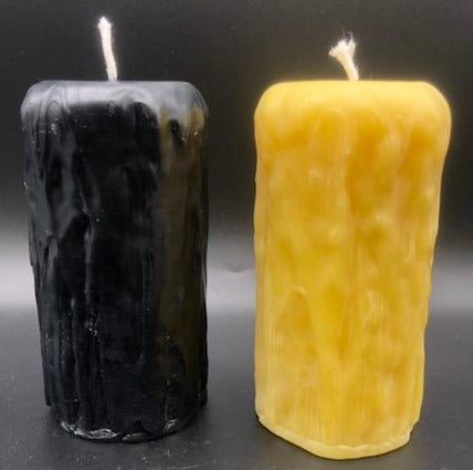 Rustic Beeswax Pillar candle with wax drip pattern flowing down the sides.