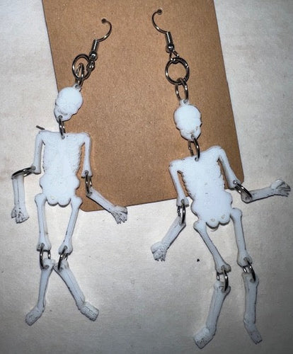 stunning dangle skeleton earrings that are sure to turn heads and make a statement wherever you go. Crafted with intricate attention to detail, these earrings feature a unique design that allows the arms and legs of the skeleton to swing freely, adding an extra element of movement and fun to your look.