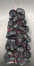 Load image into Gallery viewer, Bleeding Skull Beeswax Candle, piles of skulls and bones with a red leaking core.  Black and red option pictured.
