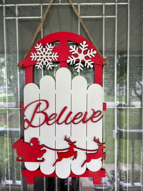 Ring in the holidays with this adorable Sleigh Door Hanger.  Available in 2 styles. Approx. 19