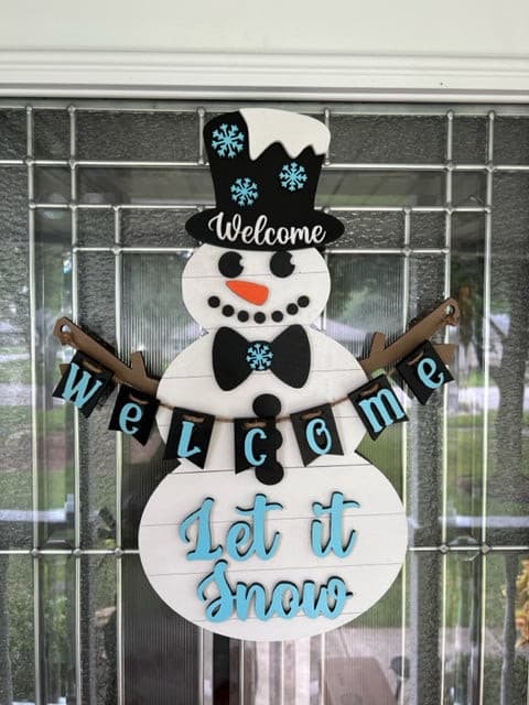 Let this adorable Snowman or Snowwoman Door Hanger welcome your guest this winter.
