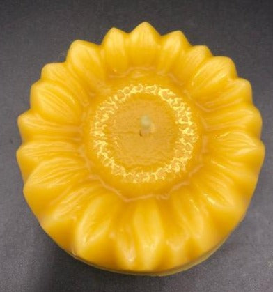 Adorable Sunflower shaped beeswax candle. This bright and cheery beeswax candle is sure to brighten everyone's day. A slight shimmer of gold mica in the center adds a touch of whimsey to this summer favorite.
