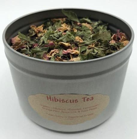 Hibiscus tea, shown in tin. Rosehips, rose petals, lemonbalm