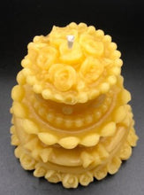 Load image into Gallery viewer, Adorable wedding or birthday cake design. This all natural beeswax candle in the shape of a beautiful cake adorned with roses and ribbons. Handmade in the USA.
