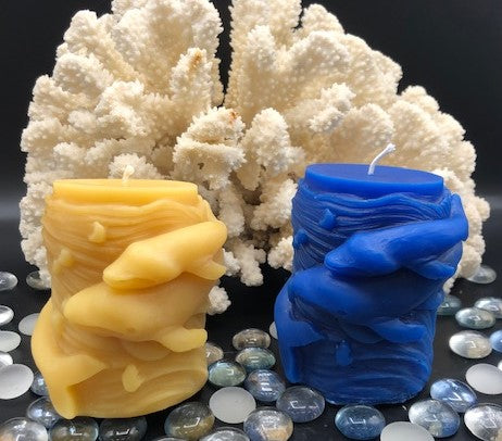 Mother and baby whale swirl around the outside of this all natural beeswax candle. Around the whales is an ocean wave design. Handmade in the USA.  Available in natural beeswax or blue.