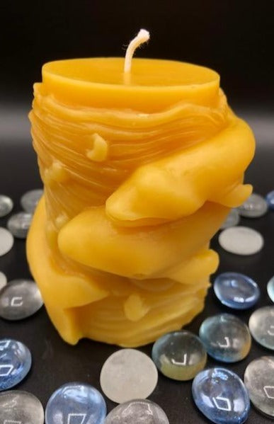 Mother and baby whale swirl around the outside of this all natural beeswax candle. Around the whales is an ocean wave design. Handmade in the USA.