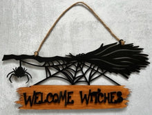 Load image into Gallery viewer, Welcome all the Witches to your home with this Welcome Witches broom sign. A creepy little spider hangs off the end to add an extra bit of Halloween fun. Great for Halloween Parties, gifts for the Halloween lovers in your life or to spruce up your Halloween decor. Witch broom on top with a creeping spider hanging off the side &amp; a spider web below. Wood sign attached to the bottom reads &#39;Witches Welcome&#39;.
