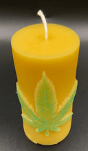 Load image into Gallery viewer, Leaf design beeswax candle. Leaf design on front of this candle shown with green sparkle mica leaf.
