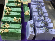 Load image into Gallery viewer, These luscious lavender &amp; lily bar soaps help your skin stay moisturized and soft and add a beautiful touch to any bathroom.  Dried flowers were sprinkled across the tops of the soap.  Bring a touch of spring to your home with these amazing soaps!
